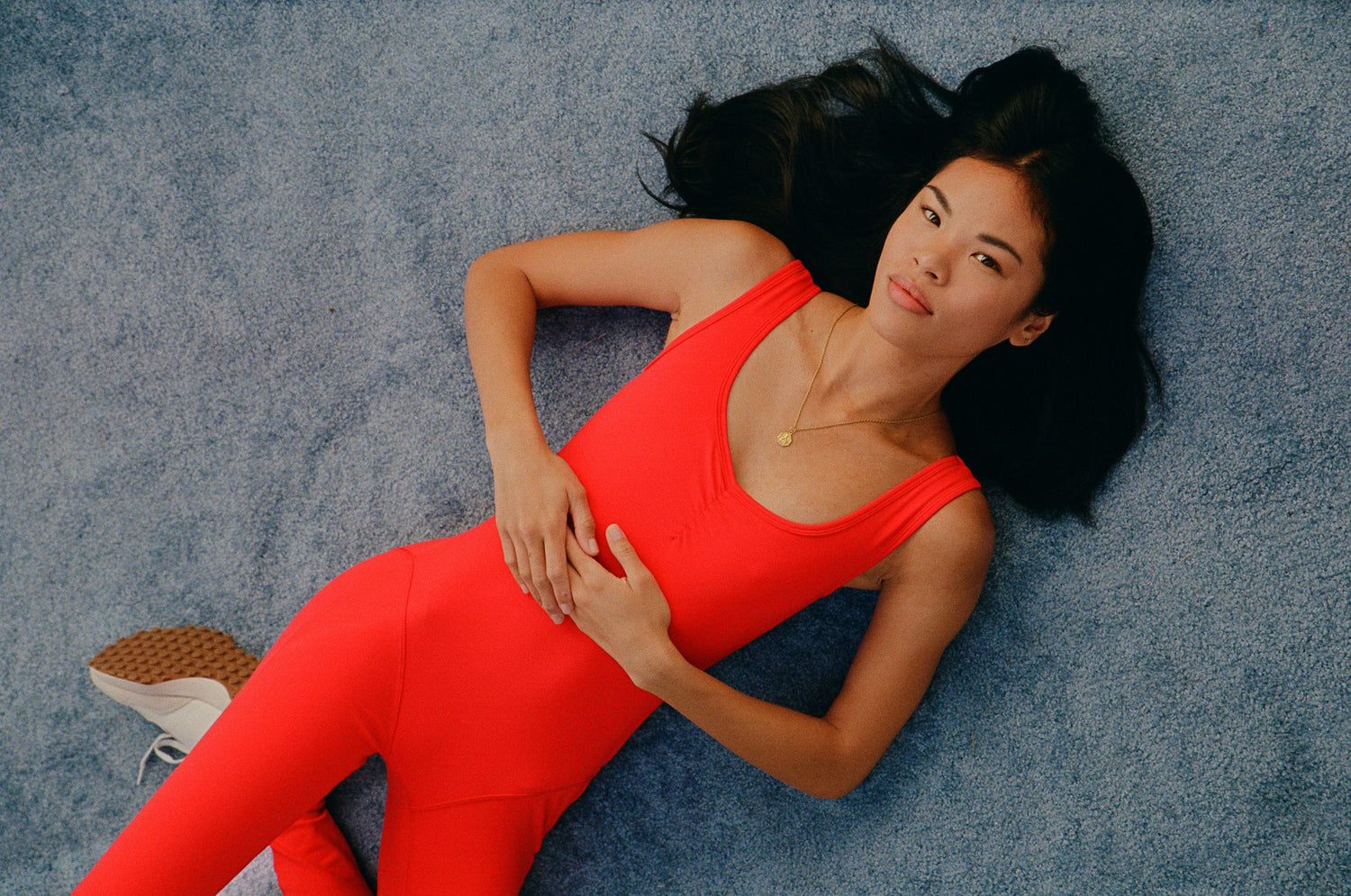 Young woman wearing a Red Jasper Even Flow Unitard.